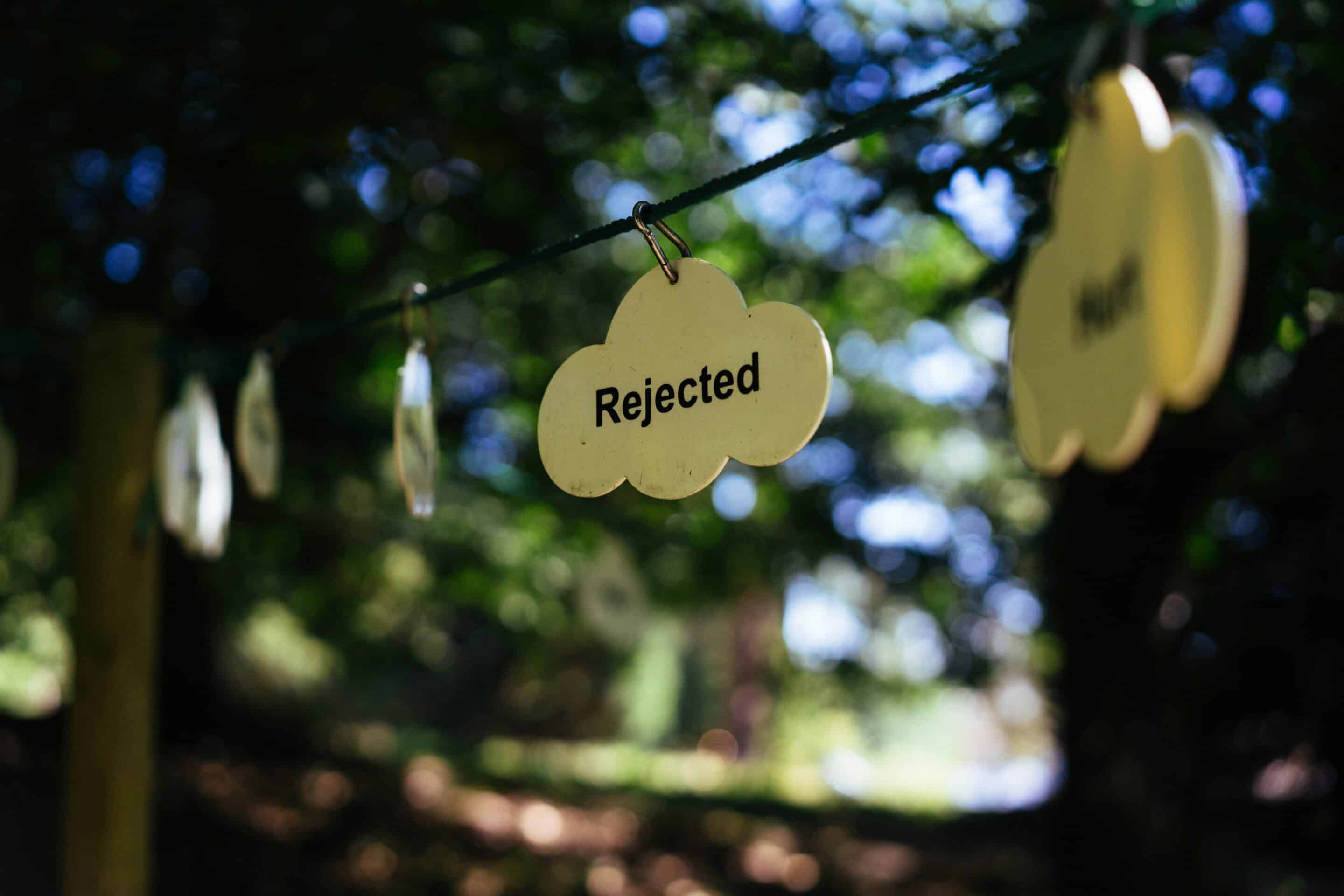 Rejection in Business photo of rejected sign hanging on string