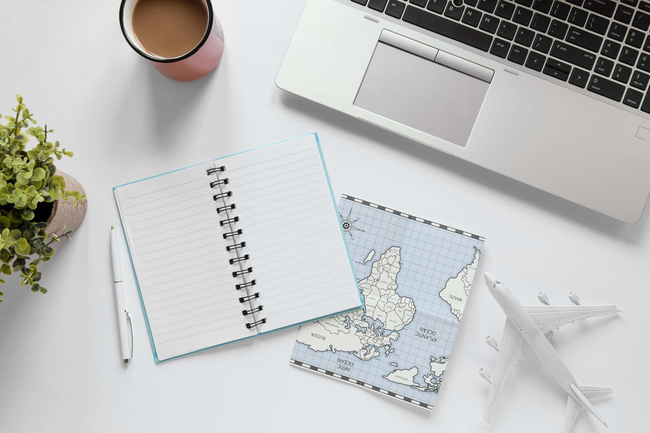 Run UK Company Abroad photo of desk with laptop, notebook and world map being displayed